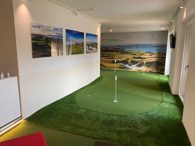 Flagstaff indoor putting green in an office with scenic wall art